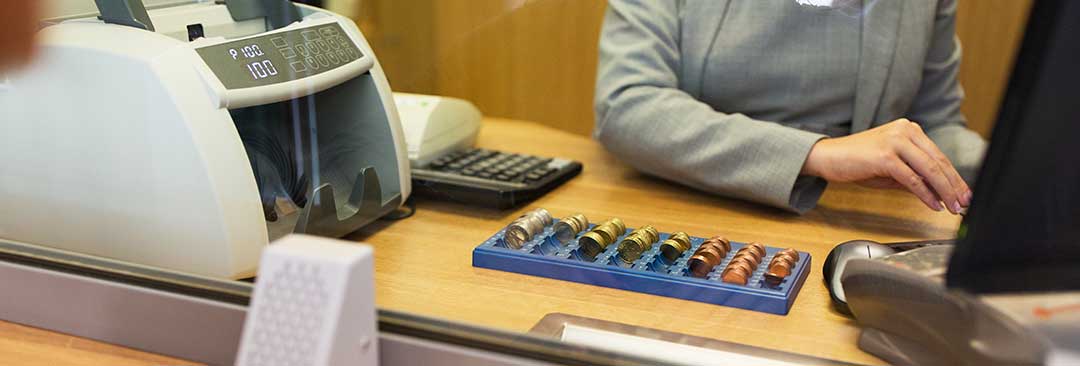 A teller at a bank signifying the corporate obligation.