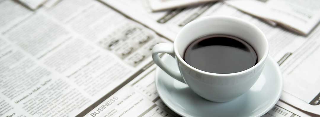 A coffee cup over a newspaper to indicate that publication in a newspaper is one of the requirements of probate.