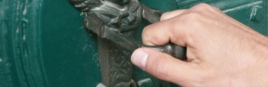 A hand knocking on a green door, showing the return of the missing spouse.