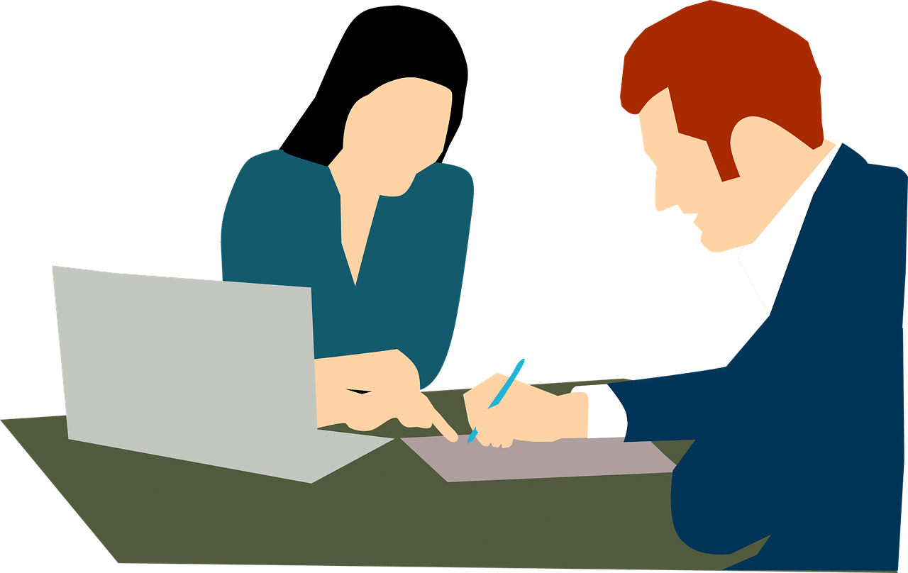 A woman watching as a man signs a will.