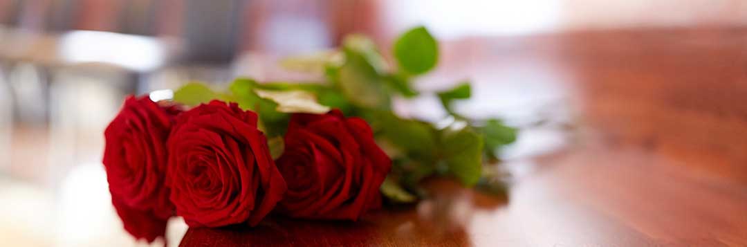 Three red roses laid on a church bench to denote a funeral. Can a foreigner inherit land in the Philippines? Only from their Spouse!