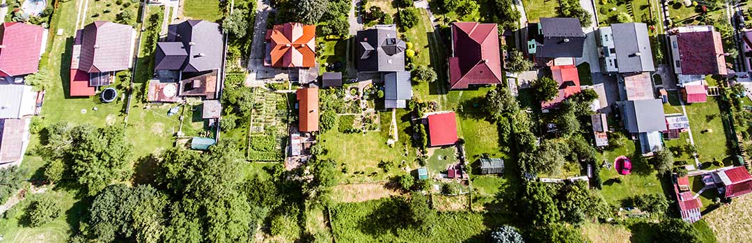 An aerial photo of 9 houses on 9 plots of land to indicate that a foreigner can build and own a house in the Philippines but not the land it is built on. Inheritance Rights of a surviving spouse Philippines, Can a foreigner inherit Philippine land 