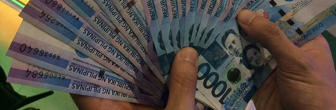 A photo of two hands fanning out a lot of One Thousand Pesos bills symbolizing that after court proceedings, each Spouse will then control his own Estate. 
