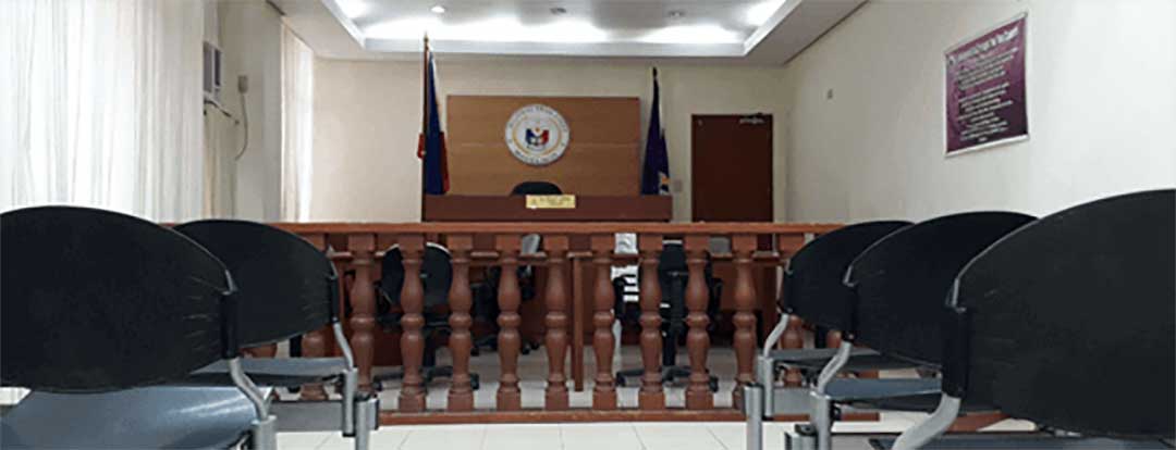 A photo of a Philippine Regional Trial Court, with rows of chairs, a wooden partition and the Judges desk and chair at the front.   How to file Recognition of Foreign Divorce in the Philippines 