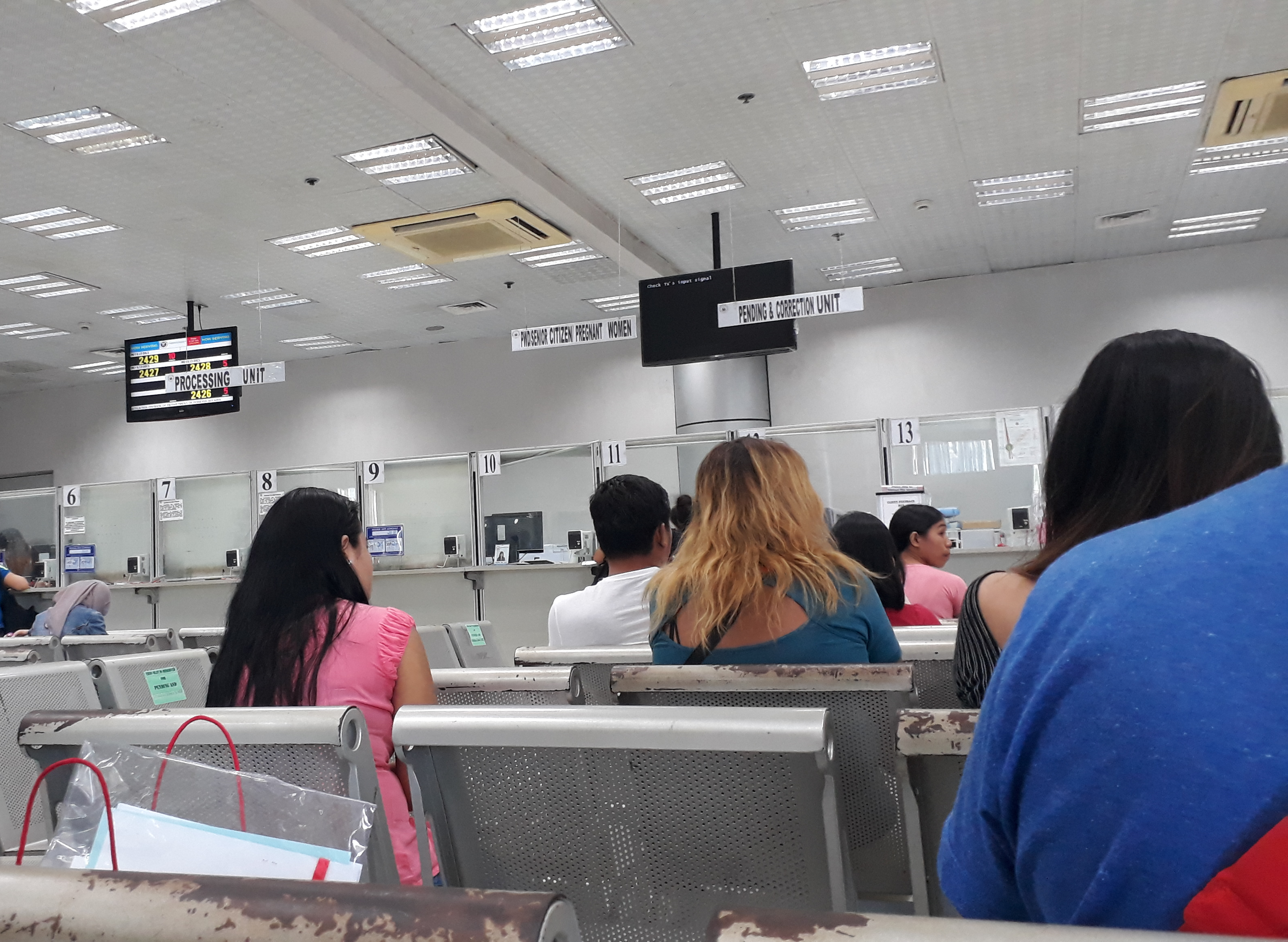 A photo of a people sat in a Department of Foreign Affairs waiting area. Where to get Apostille in Philippines.