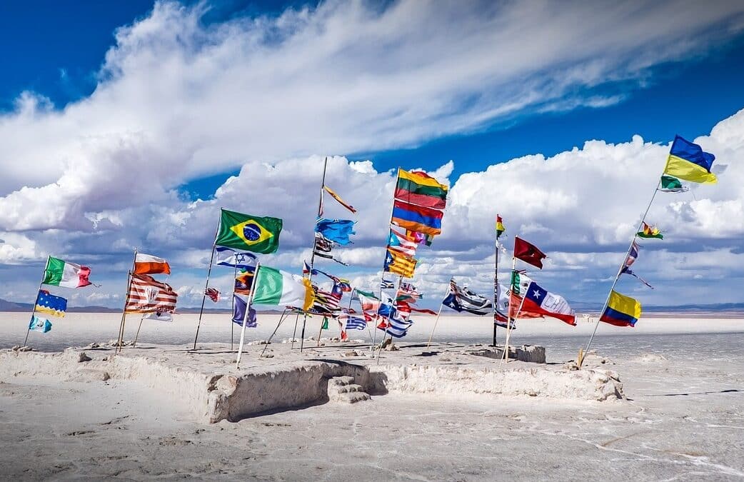 Different flags waving on a beach
