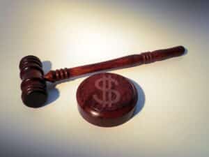 A gavel and a soundblock with dollar sign