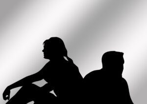 A couple in silhouette with their backs to each other, indicating problems in their marriage. When considering how to end a marriage, remember that there are big differences between Annulment vs Legal Separation.