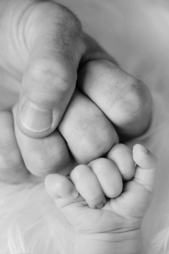 A father and baby fist bump