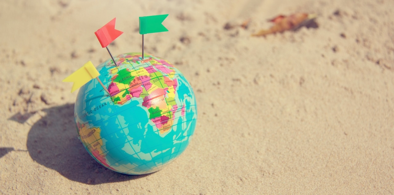 A World Globe sitting on sand with two mini flags pinned to it.  Can I file Annulment abroad?Lawyers in the Philippines