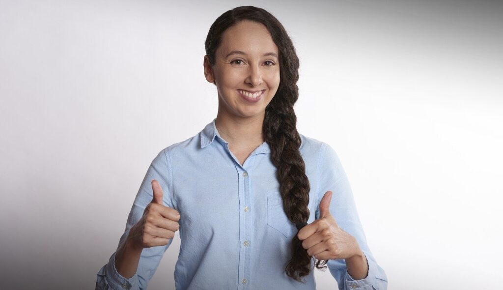 A woman doing a thumbs up