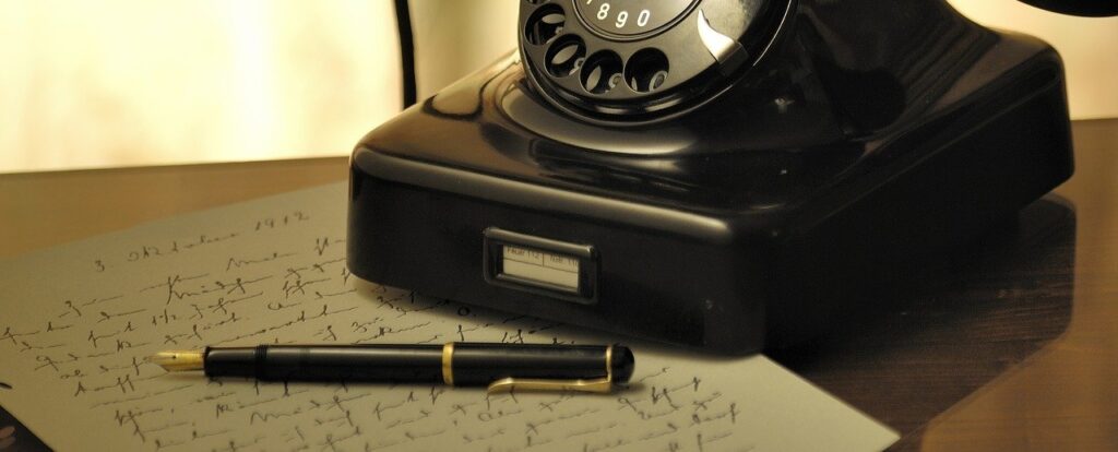 A photo of a fountain pen on top of a handwritten Holographic Will and an old telephone on the table.  A Will must comply with Philippine law whether it is a Notarial Will or Holographic Will to be valid.