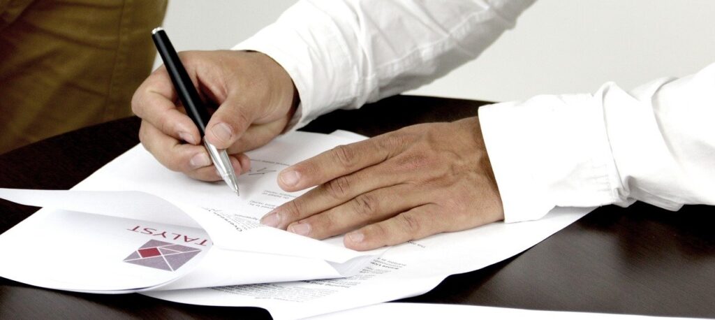 A man signing incorporation documents