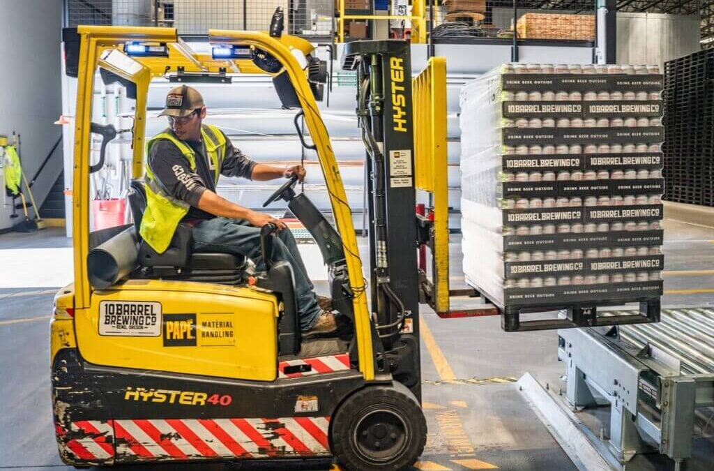 A warehouse forklift operator working in action