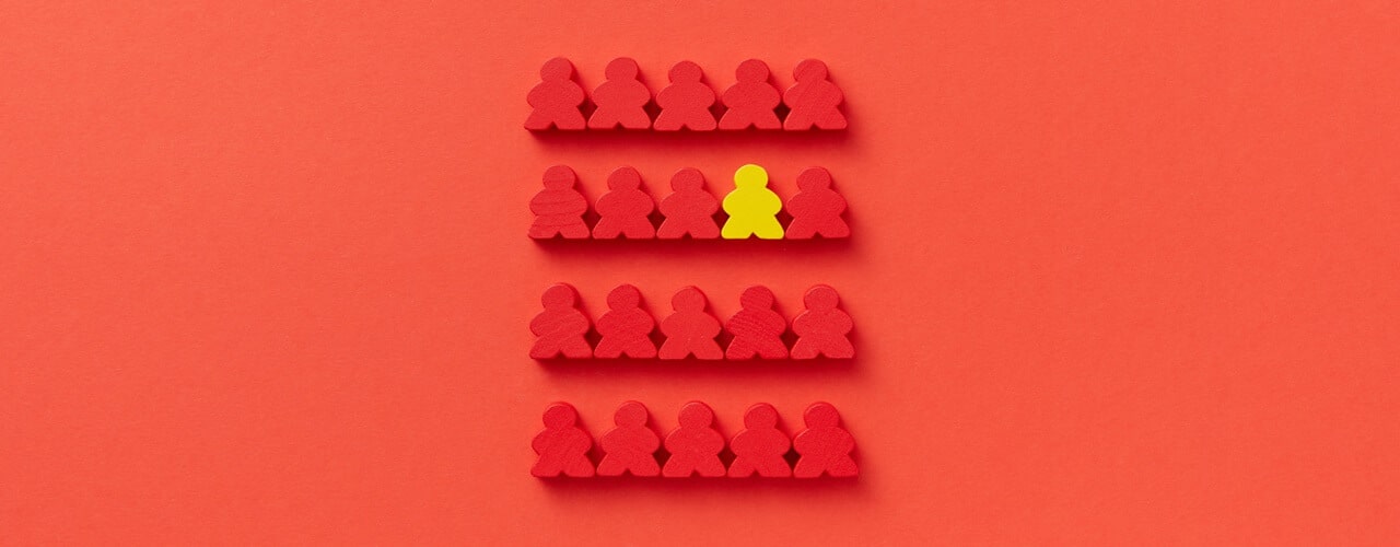 Human shaped wood color in red with one yellow symbolizing that Domestic Corporation is different from others.