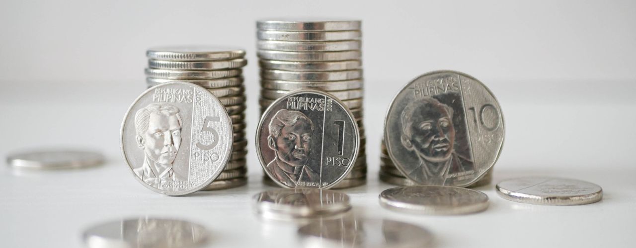 Photo of a peso coins as barangay clearance fee requirements for change of business address.