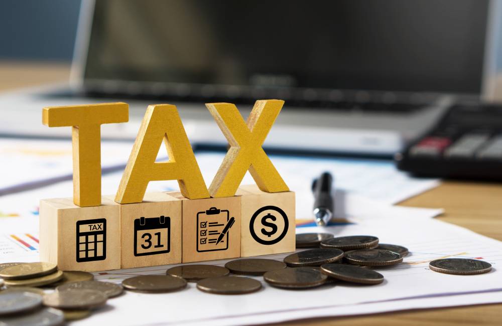A wooden set of letters spelling tax as transferring property through an Extrajudicial Settlement will mean the application of BIR Estate Taxes prior to the Land Transfer.