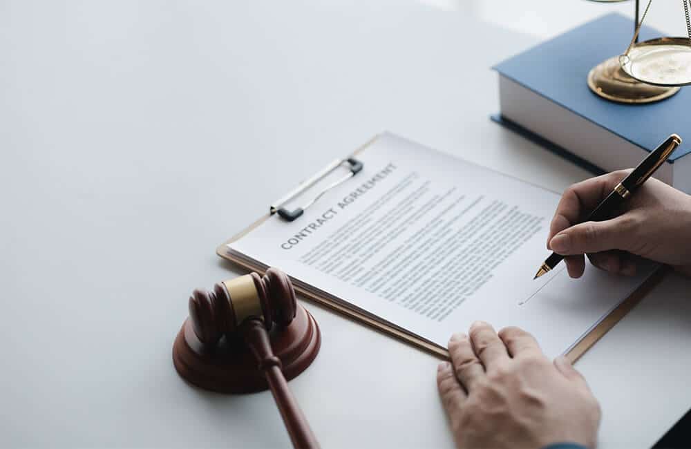 A man signing his Judicial Affidavit, showing how our experience as Property Law Firm helps us correctly prepare your witnesses for testimony. 