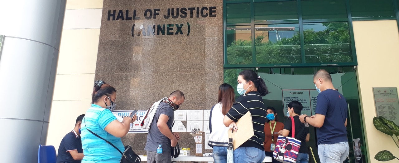 People queueing in front of a Regional Trial Court building