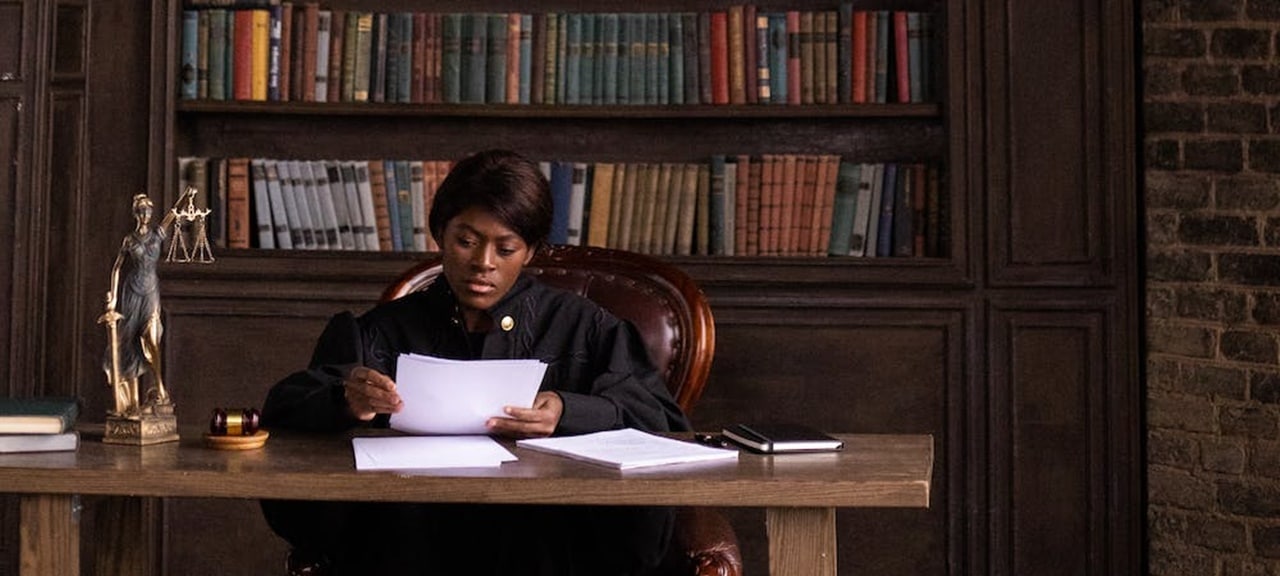 A judge reading documents in his office