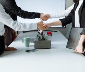 Corporate people shaking hands over a table
