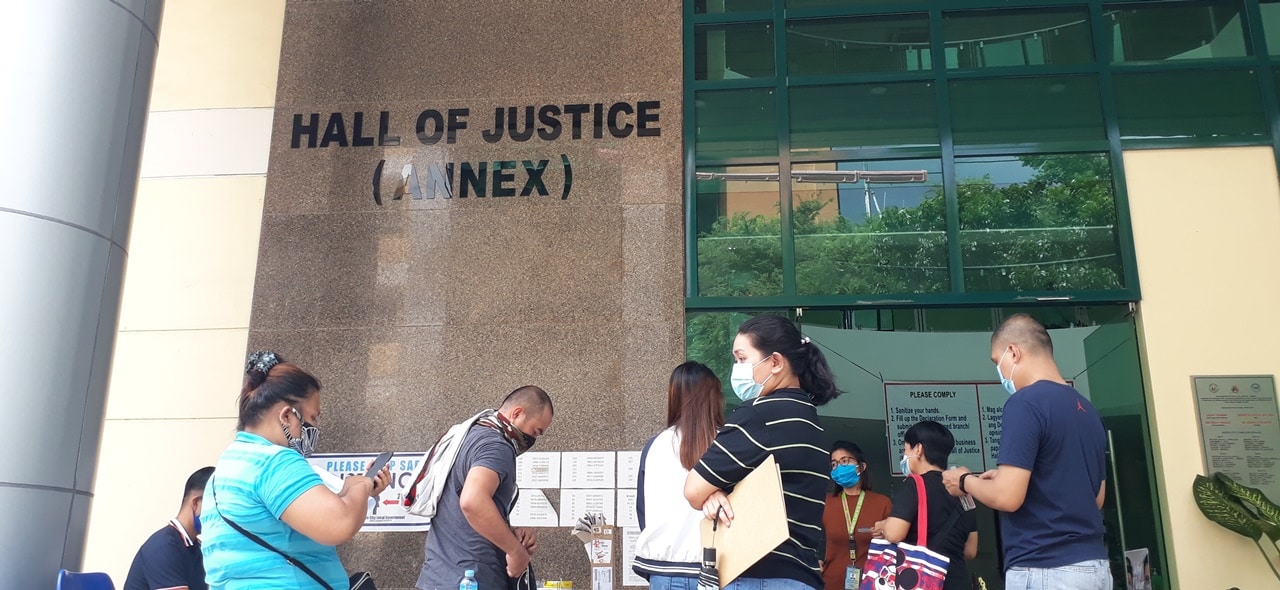 People lining up at the entrance of Quezon City Hall of Justice