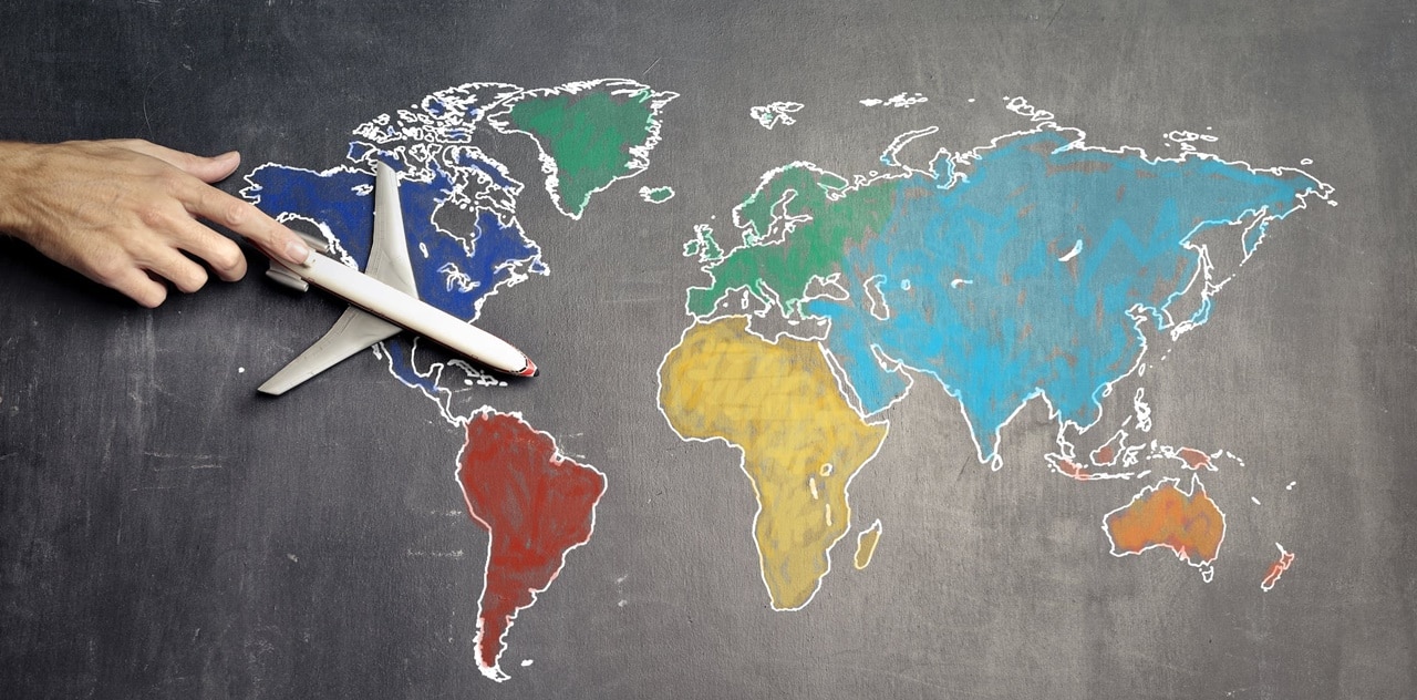 A toy plane on a colorful world map