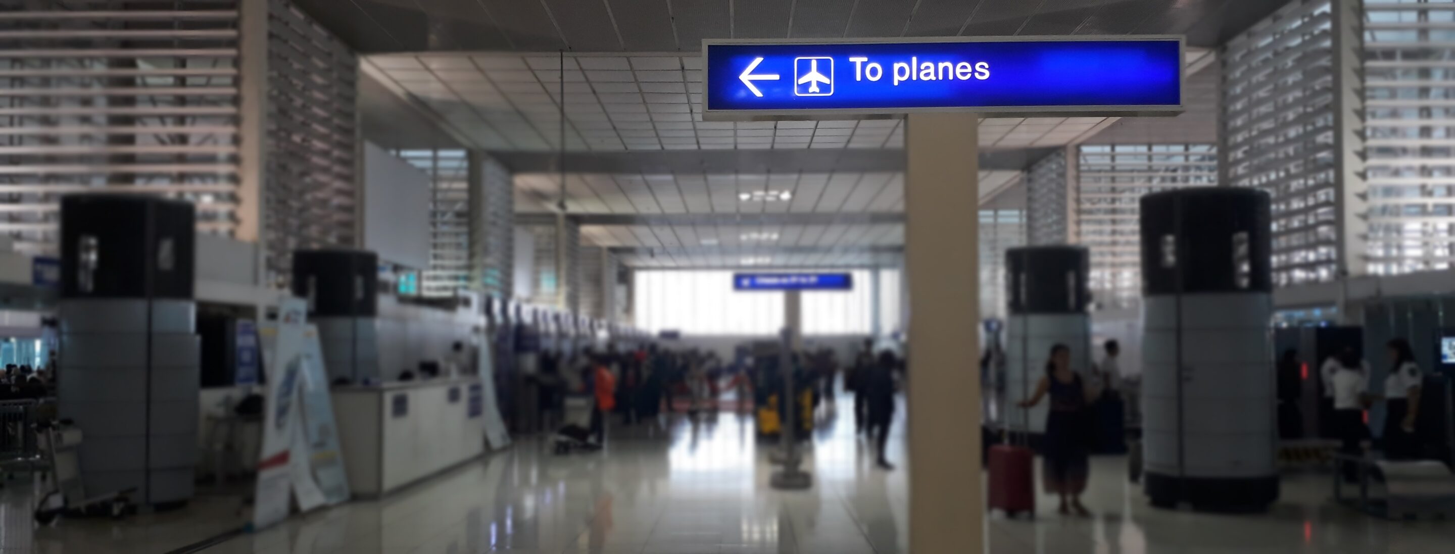 An airport terminal with a sign 