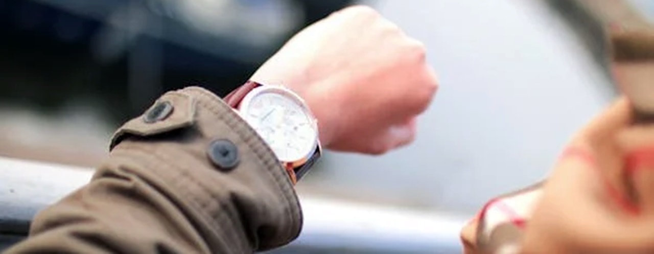 A person looking at his wrist watch