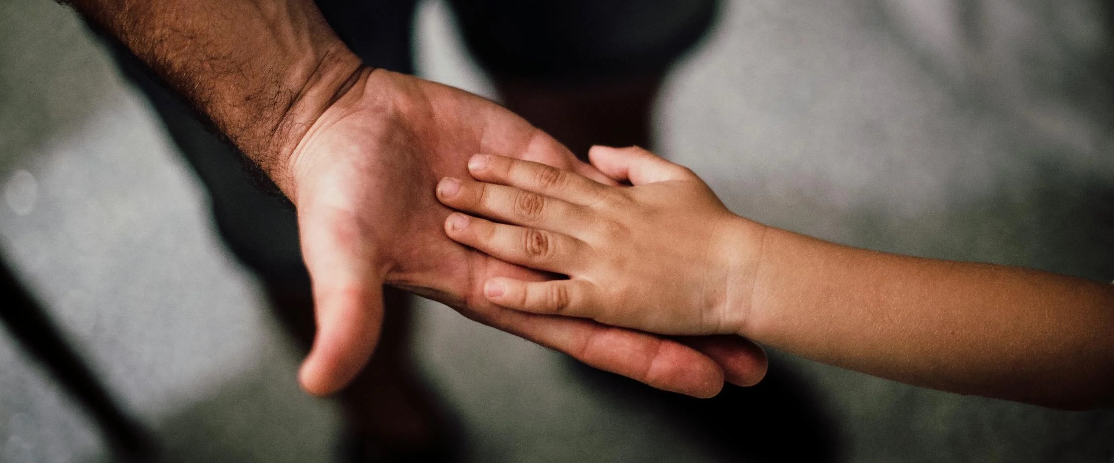 A father and son holding hands