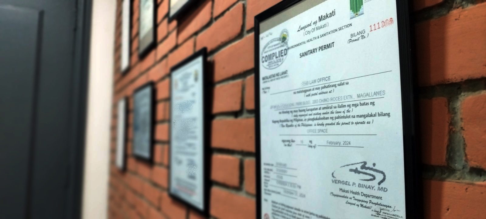 Permits and licenses on a wall is part of business registration in the Philippines