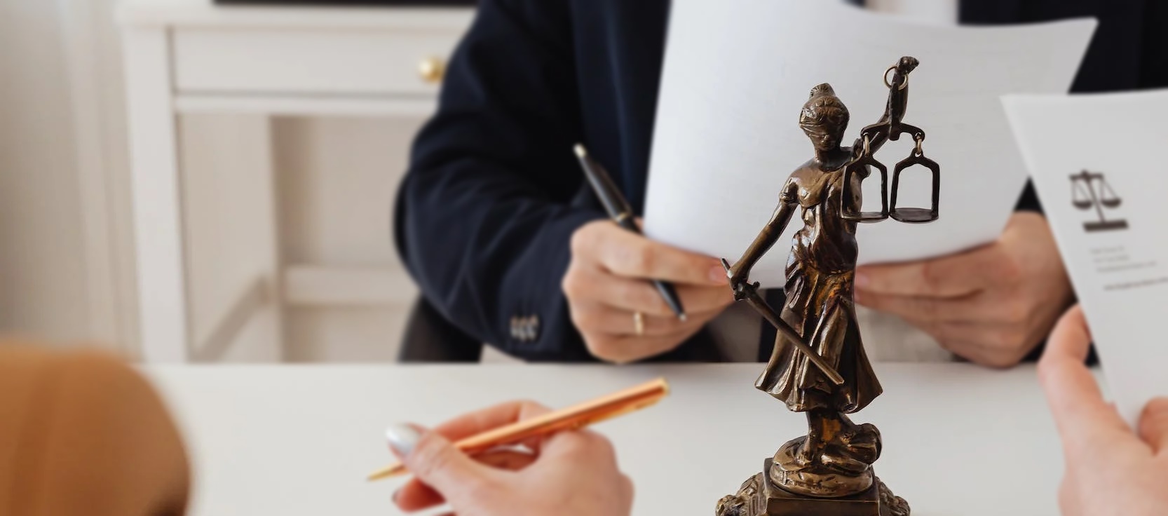 People having a discussion with the lady justice statue at the middle