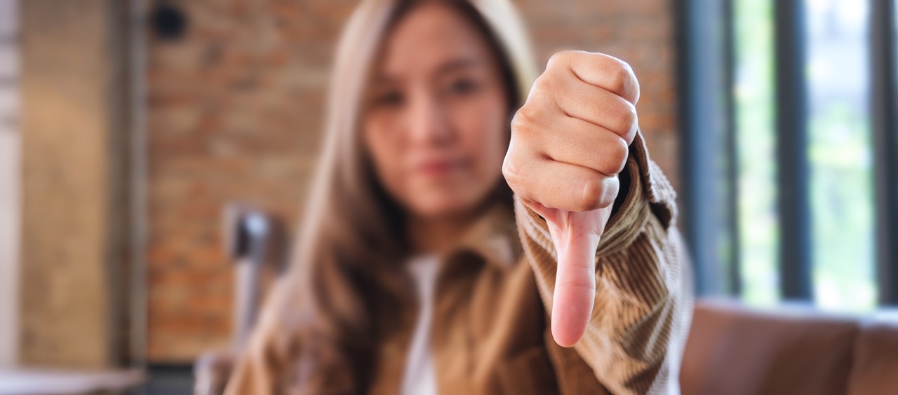 A woman giving a thumbs down