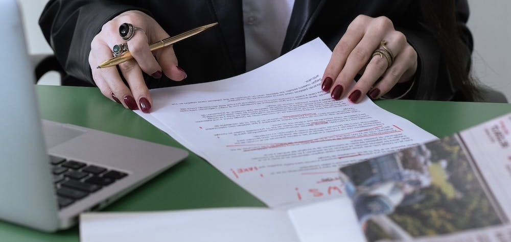 A woman checking a document in her desk