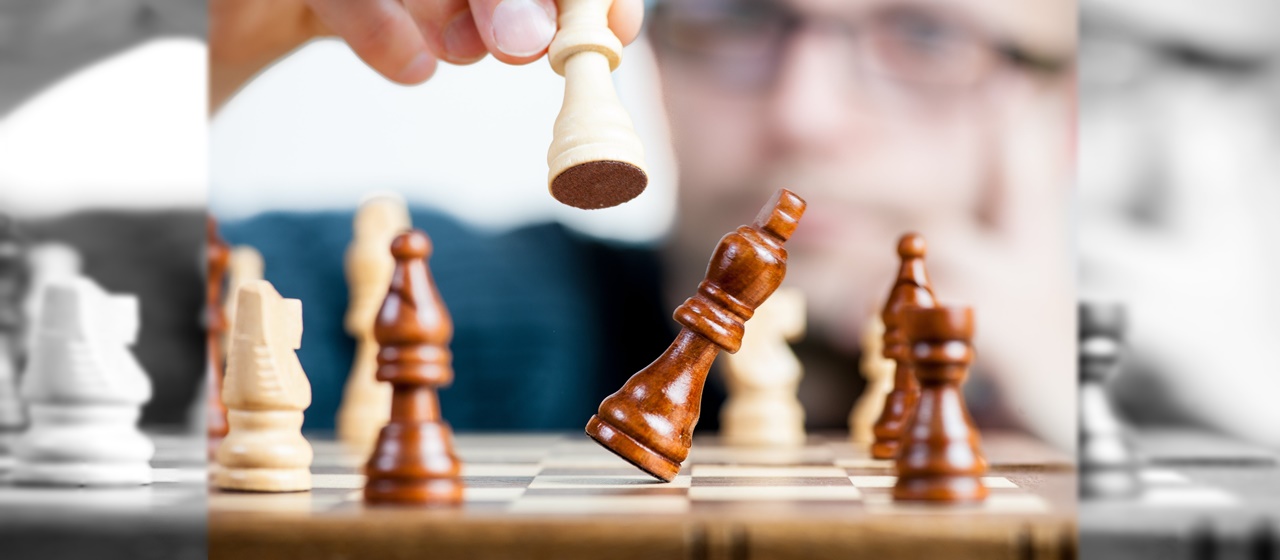 A man making a move on a chess board