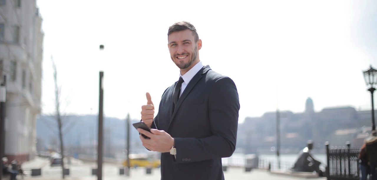 A man in formal attire smiling at the camera