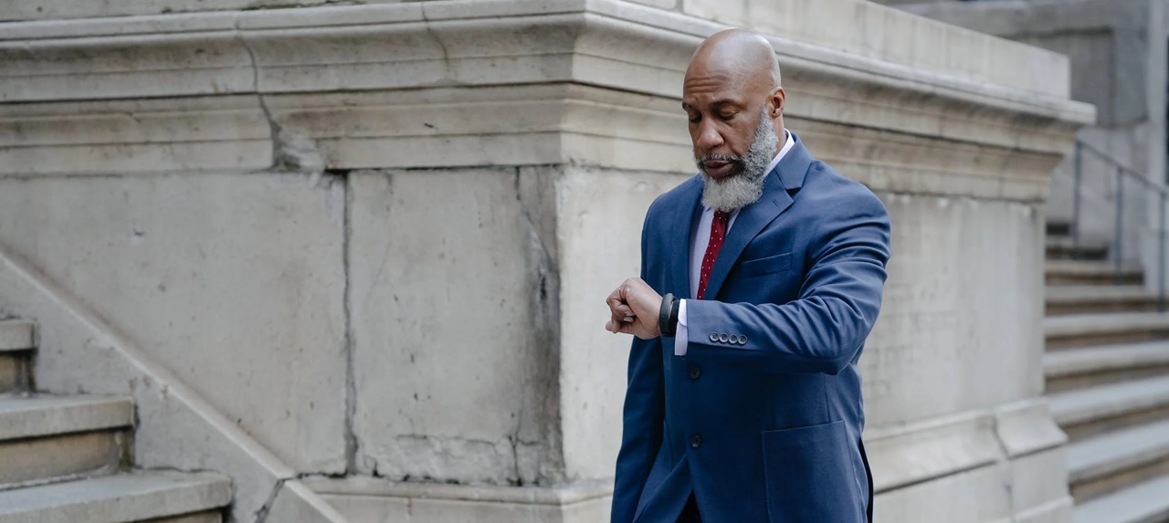 A professional man looking at his wristwatch