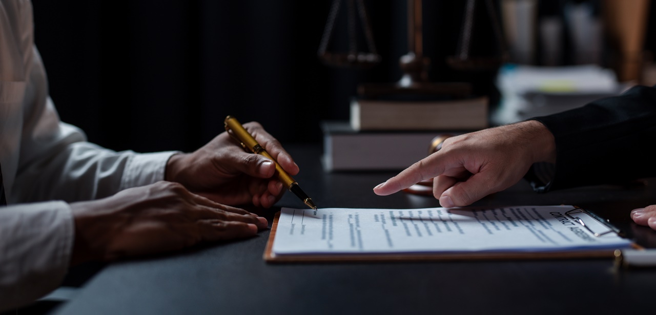 A person assisting another in signing a document