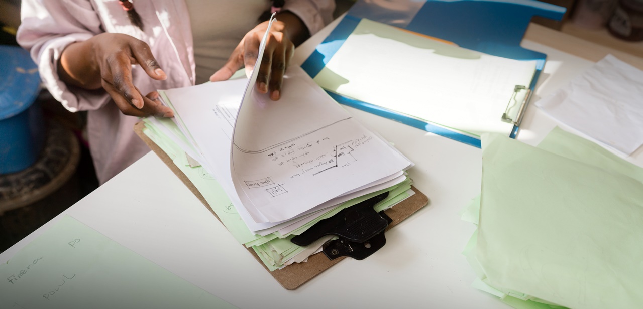 A woman checking documents on her desk