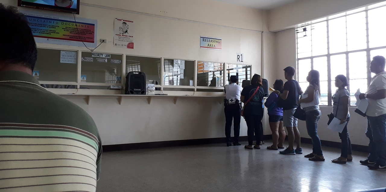 A line of people transacting in a government office