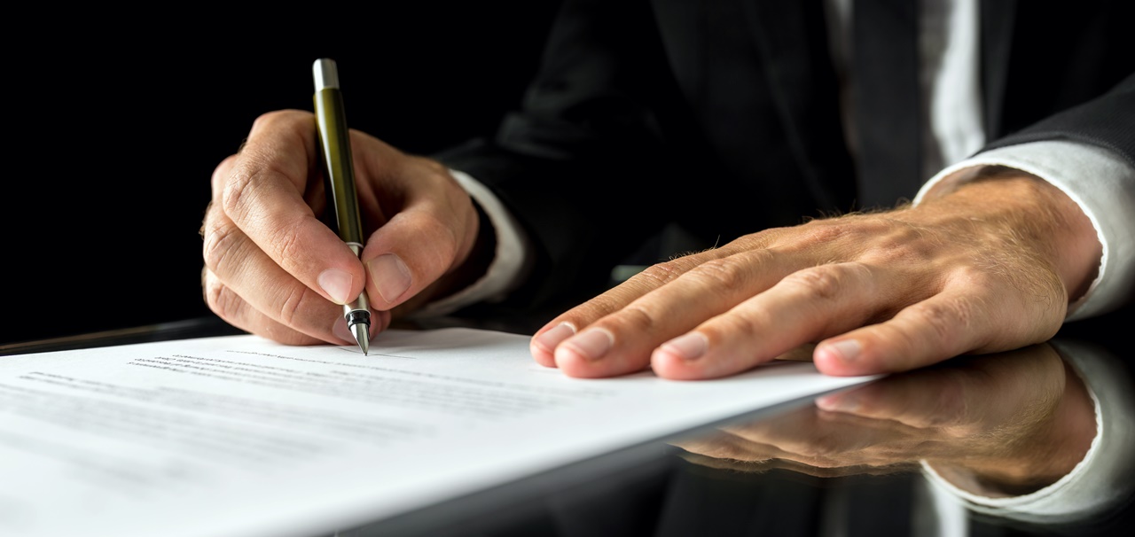 A man signing a legal document