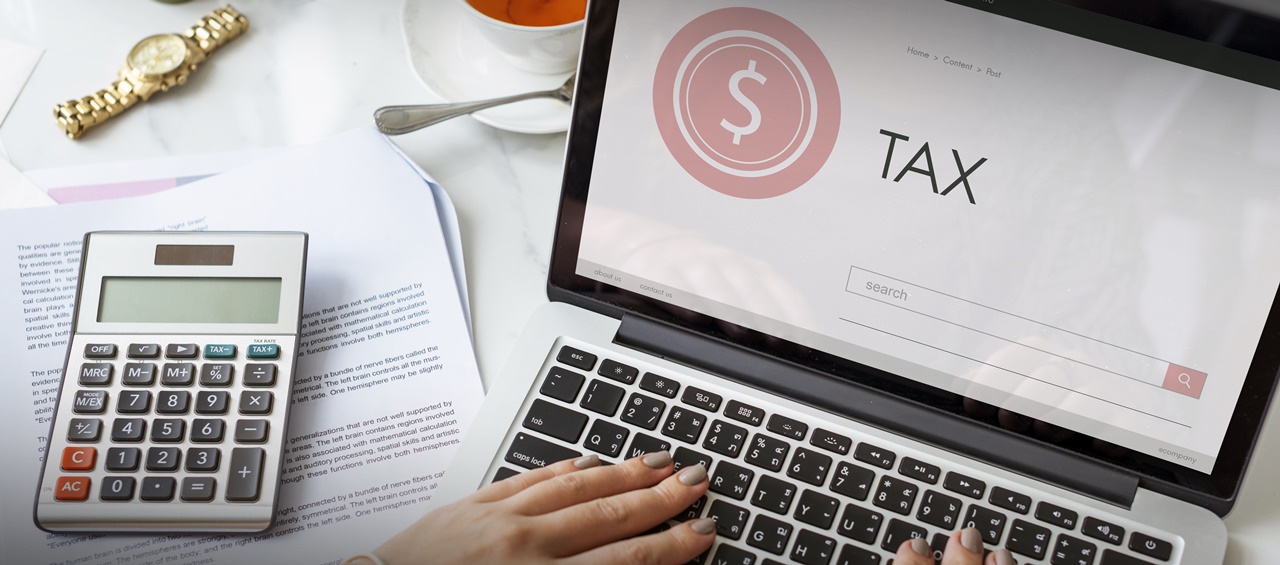 A woman on her computer calculating tax on research and development under Philippine Tax law