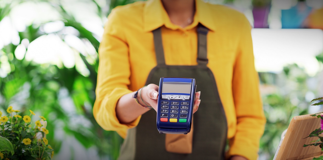 A woman giving a POS machine