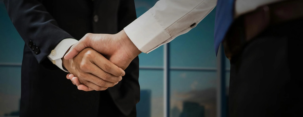 Two man shaking hands symbolizing a successful registration of a limited liability company in the Philippines