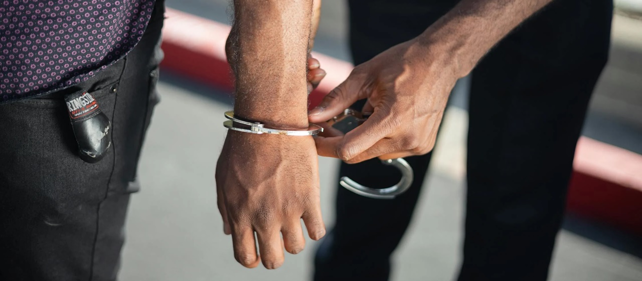 A police arresting a violator of a trademark infringement in the Philippines