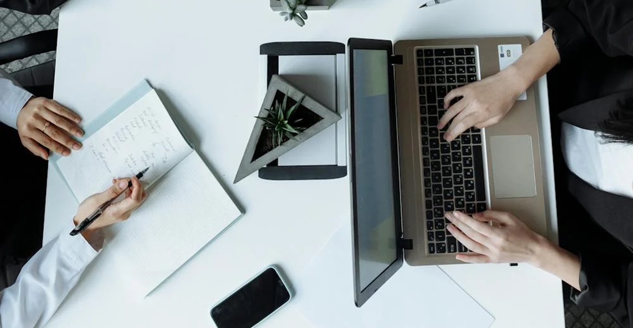 Two people on a working desk facing each other symbolizing a lawyer with updated knowledge of registration of limited liability company in the Philippines