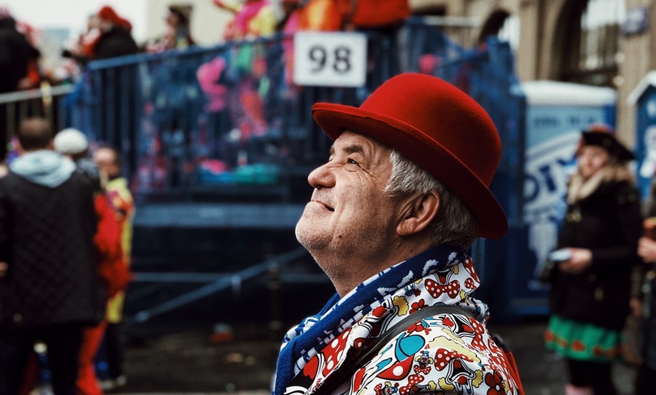 An old man in a colorful jacket with a red hat looking after getting his SRRV in the Philippines