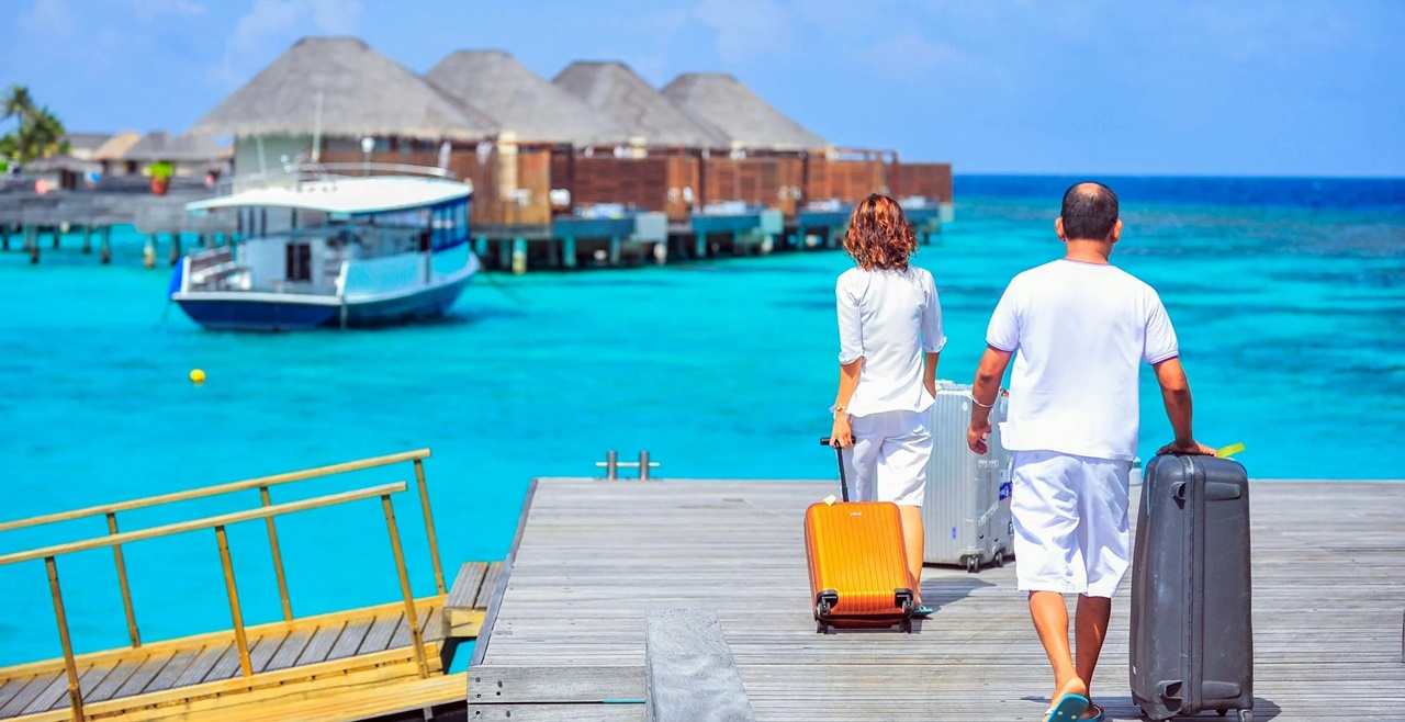 A couple with their baggage about to ride a boat after getting a 13a visa in the Philippines